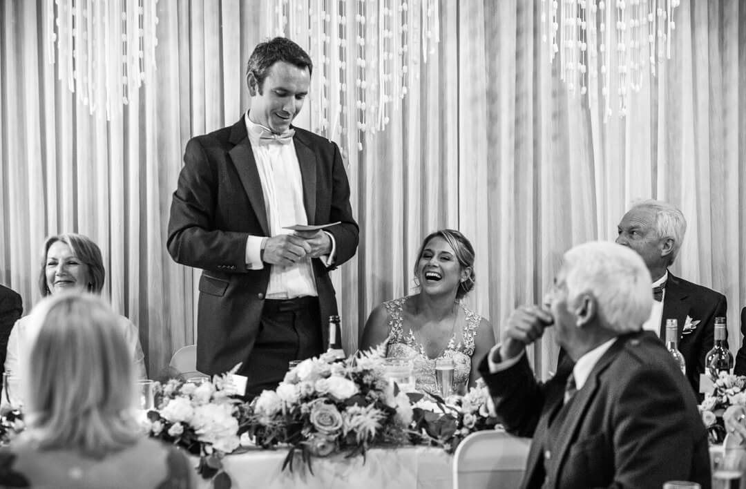 Documentary wedding photo of groom making speech