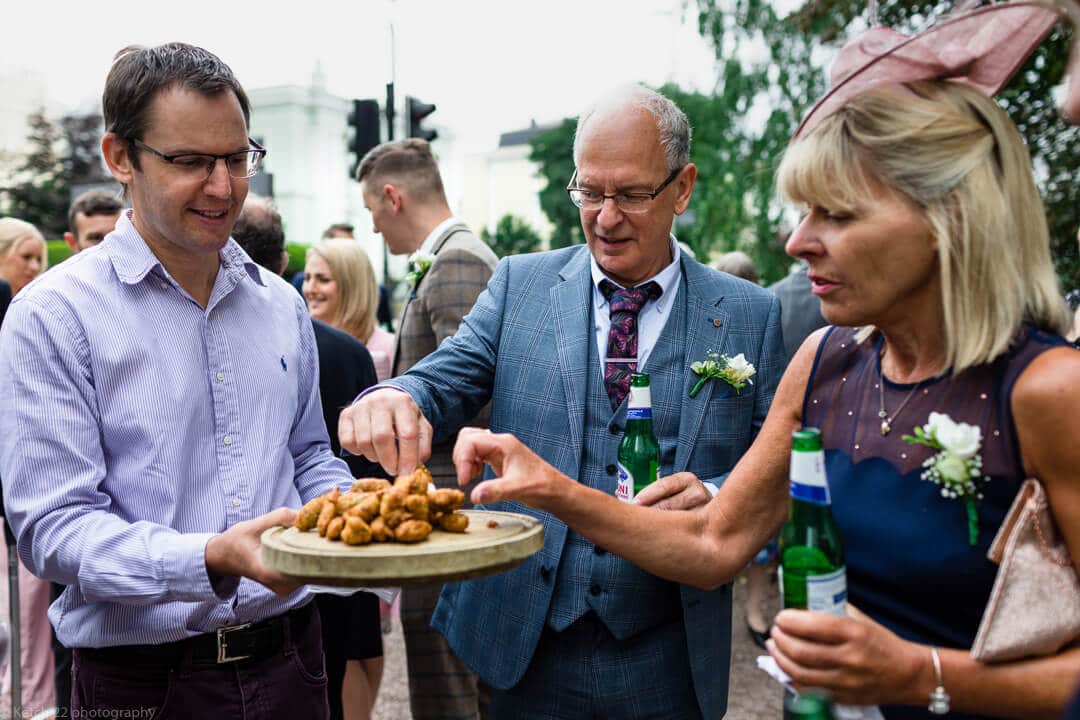 Wedding guests enjoying canapes