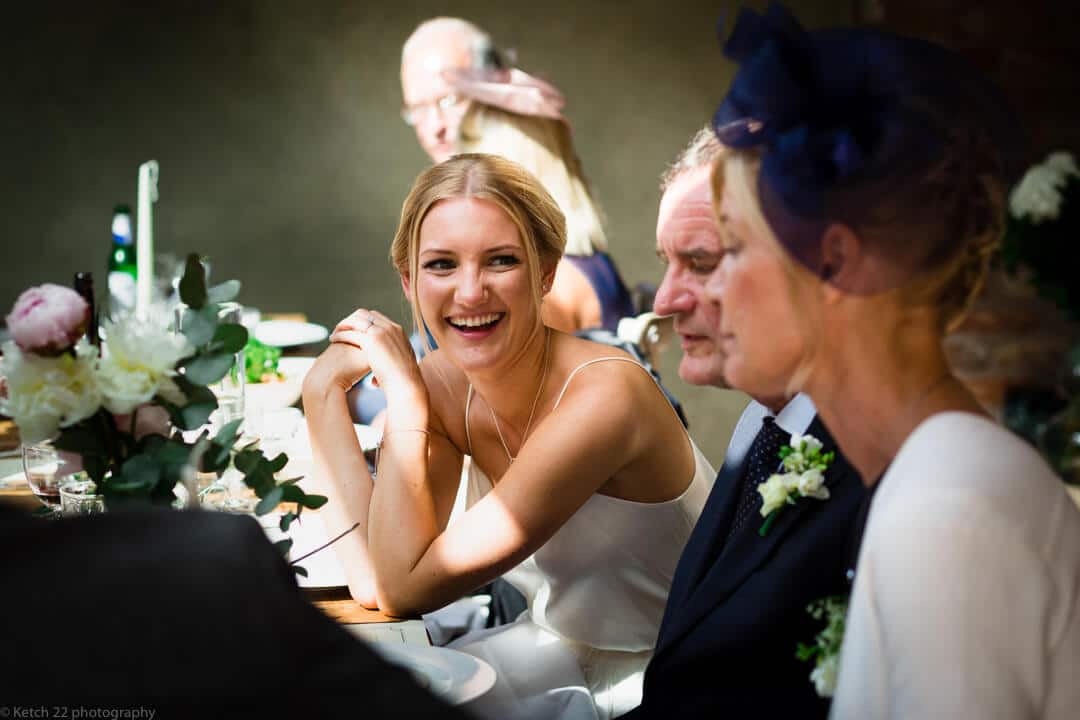 Bride laughing at wedding breakfast