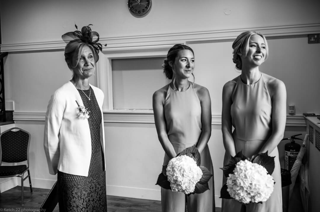 Mother and bridesmaids at wedding ceremony