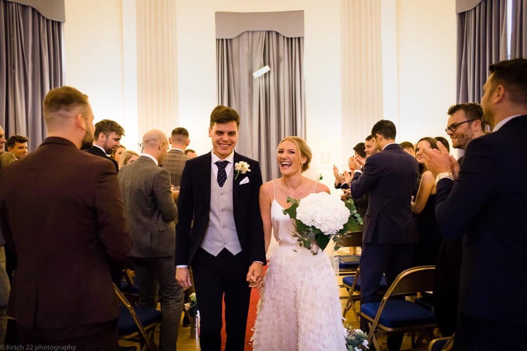 Bride and groom leaving wedding ceremony