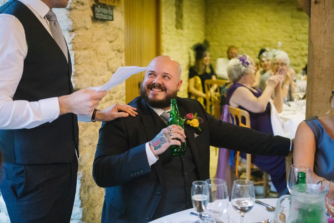 Best man laughing at Wedding speeches