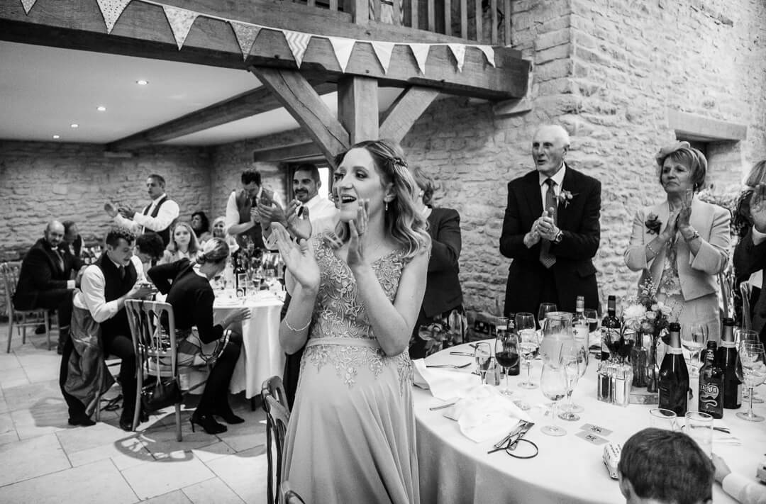 Bridesmaid cheering at wedding speeches 