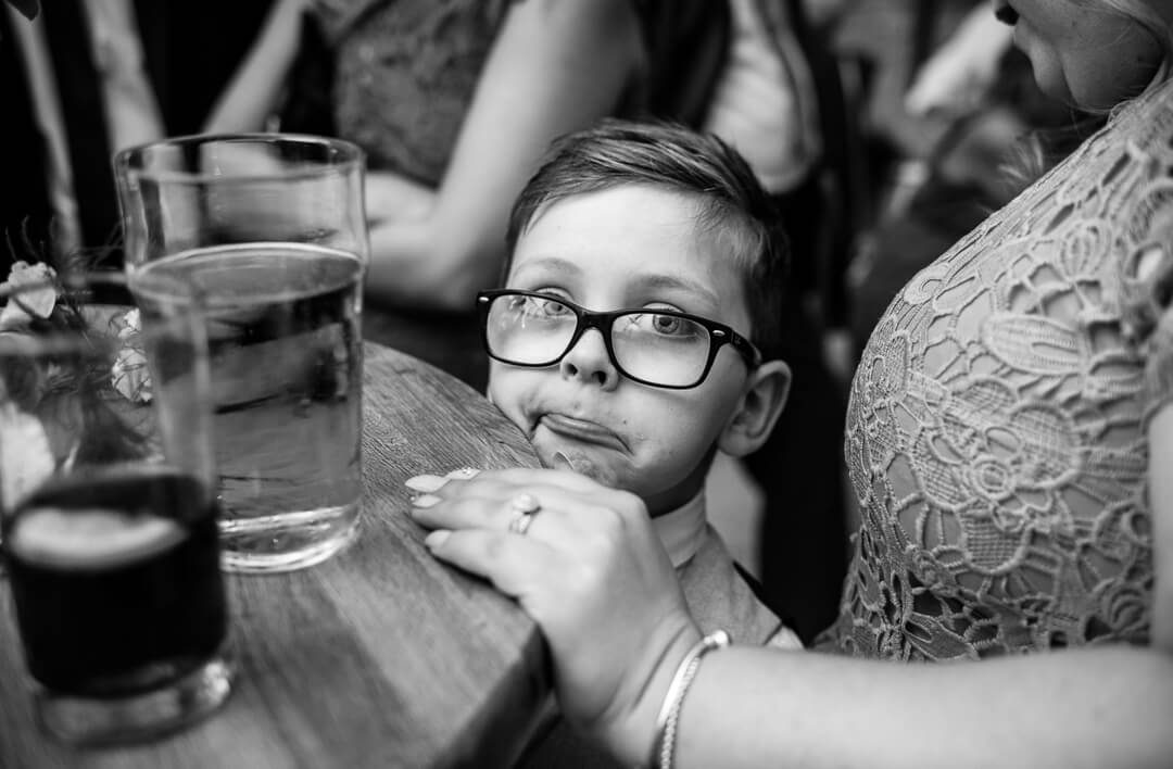 Page boy making strange face at Kingscote Barn Wedding