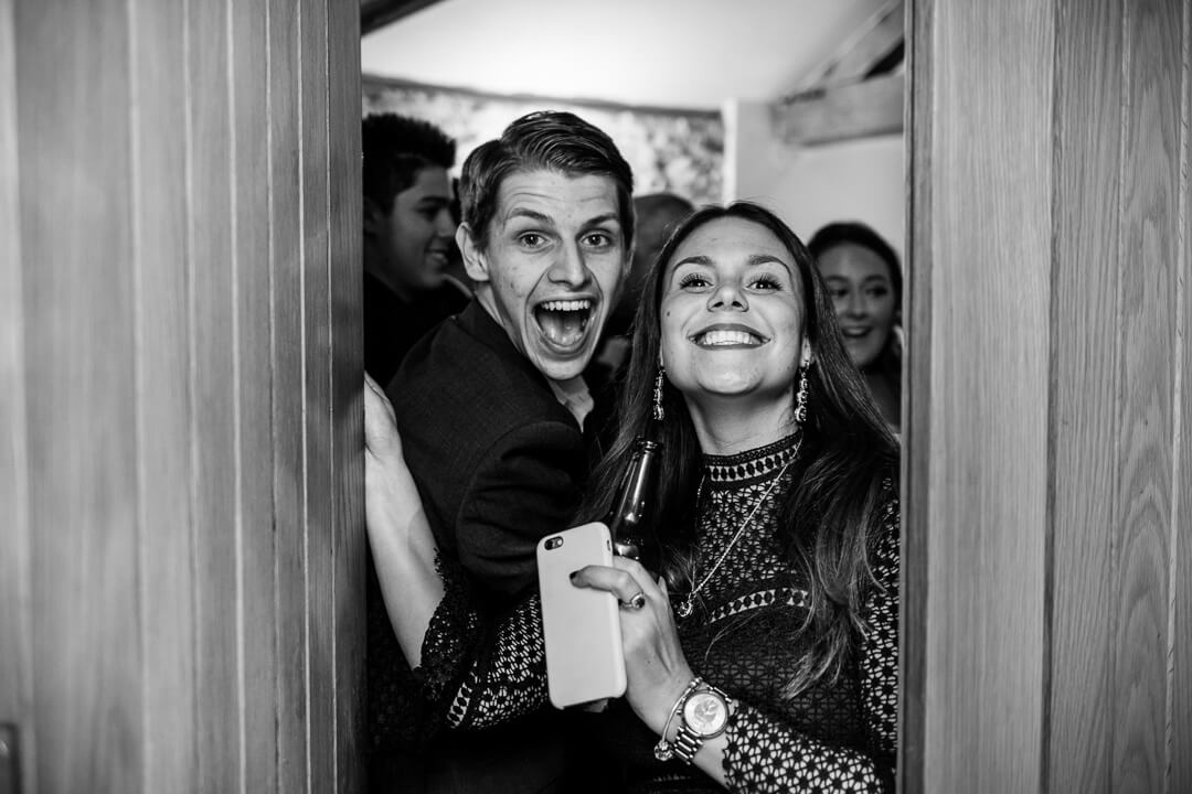 Wedding guests pose for camera at evening reception