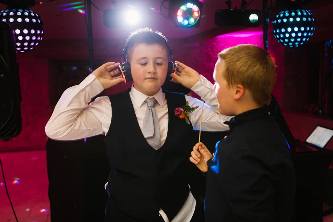 Page boy listening to wedding music on head phones