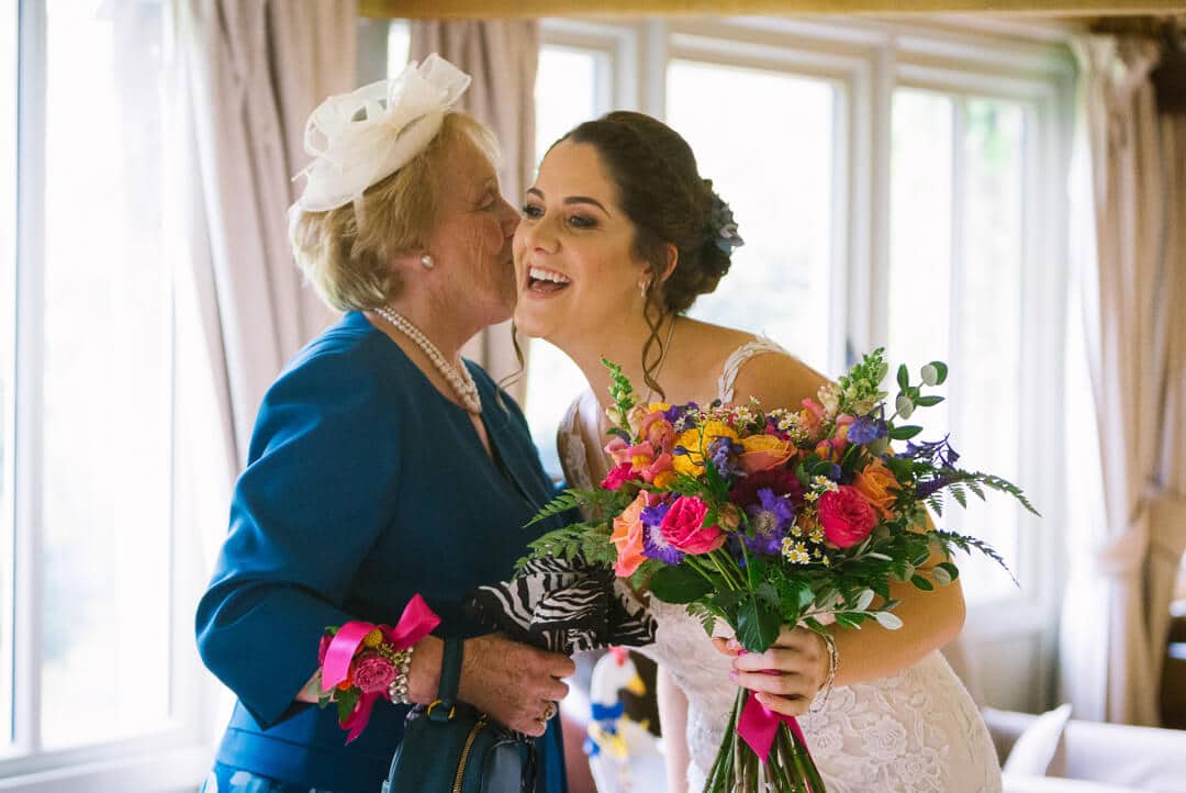 grandma kisses bride at preparations