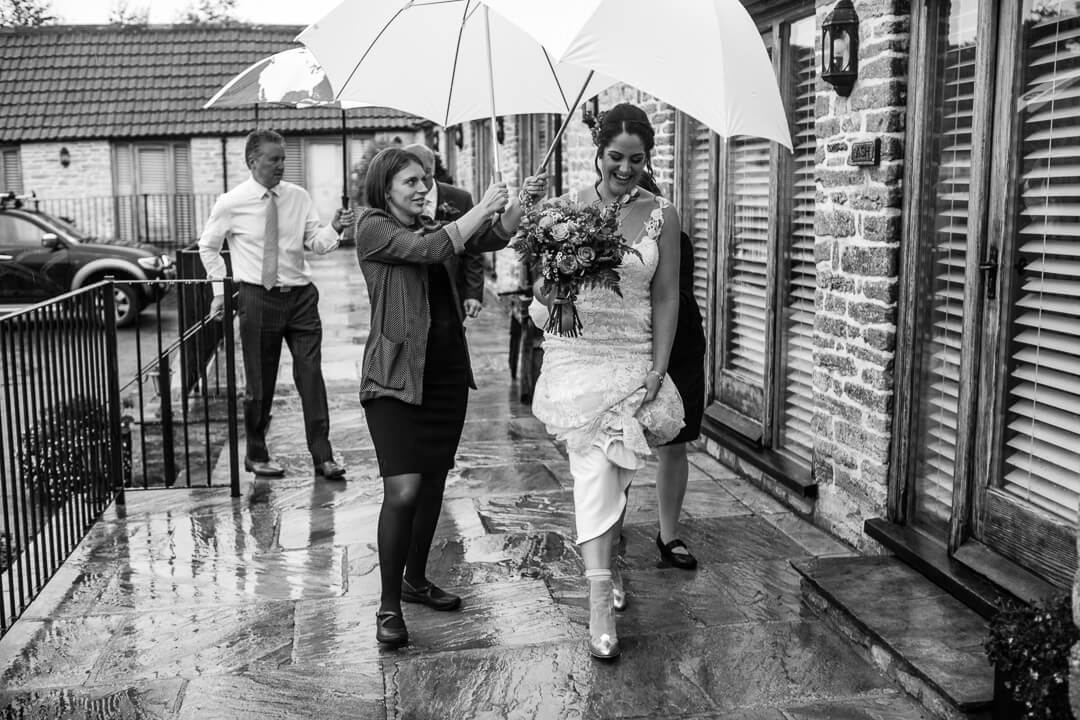 Bride arrives at Wedding on rainy day