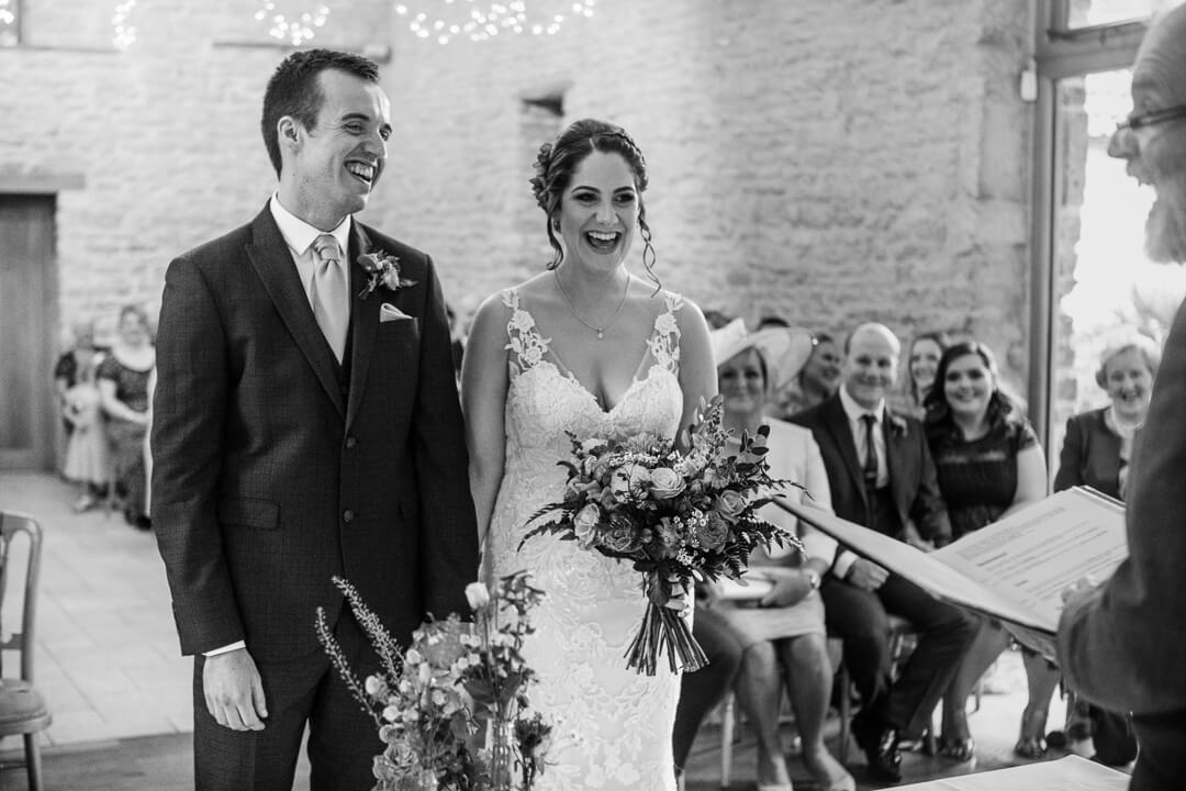 Bride and groom laughing at wedding ceremony