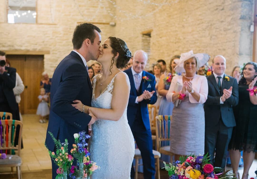 Bride and groom kissing at wedding ceremony