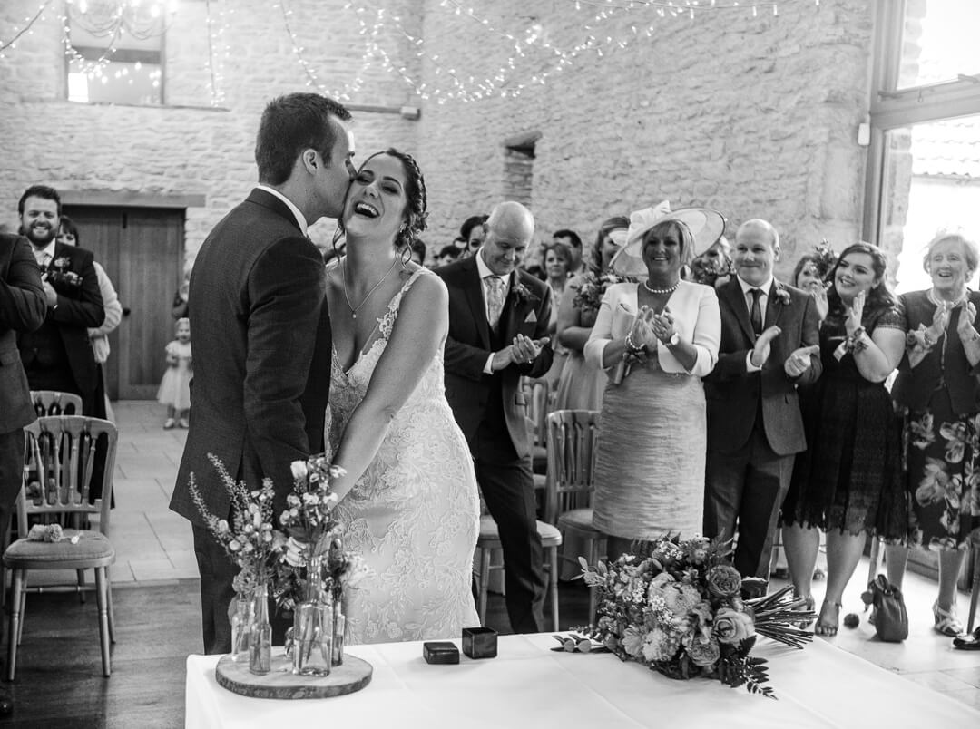 Groom looks at his bride for the first look at Cotswold Wedding