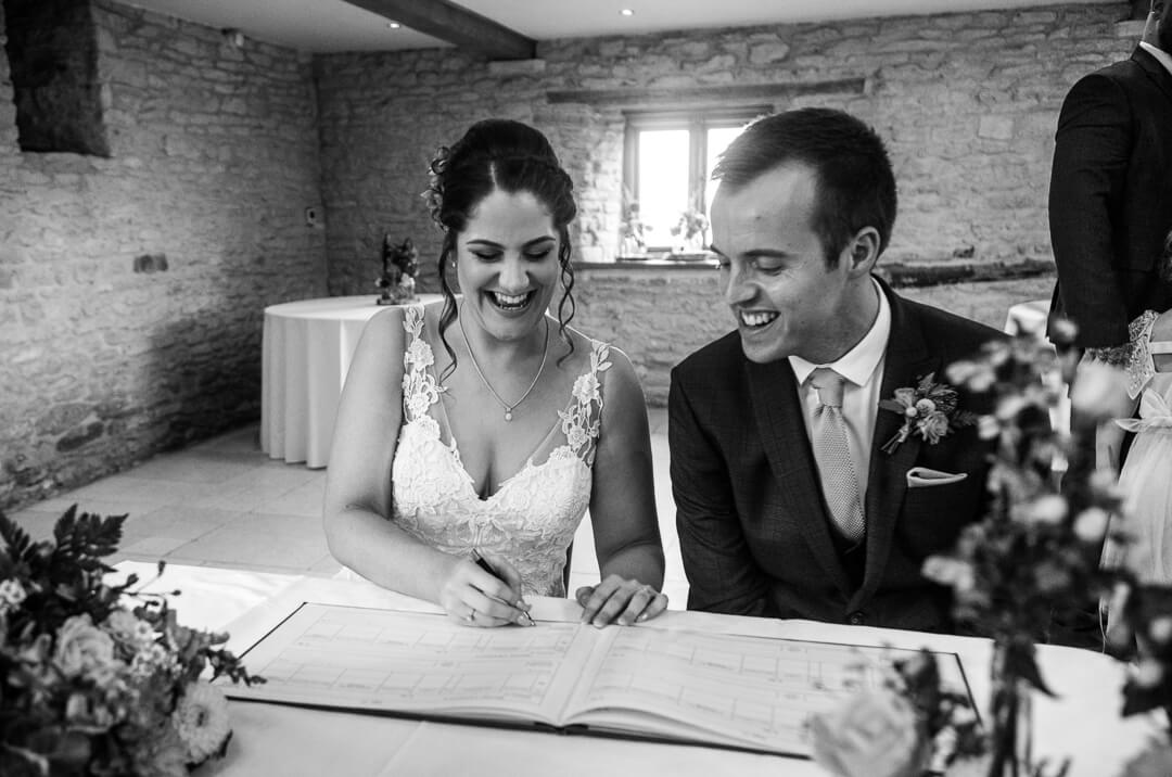 Brie and groom signing the registrar at Gloucestershire Wedding