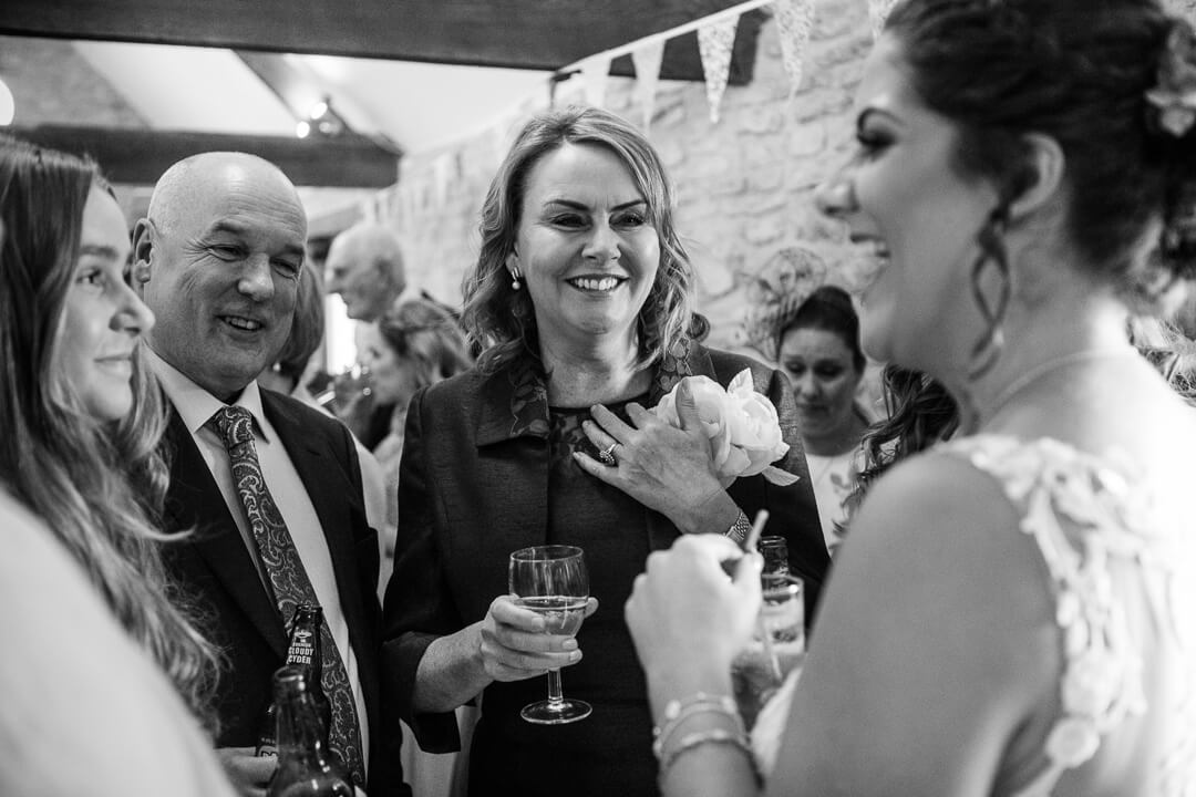 Wedding guests talking to bride at reception 