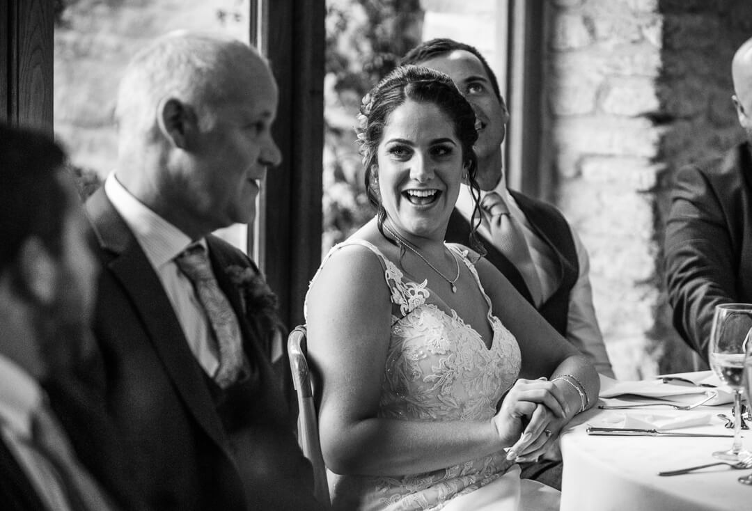 Bride looking at father during wedding speeches