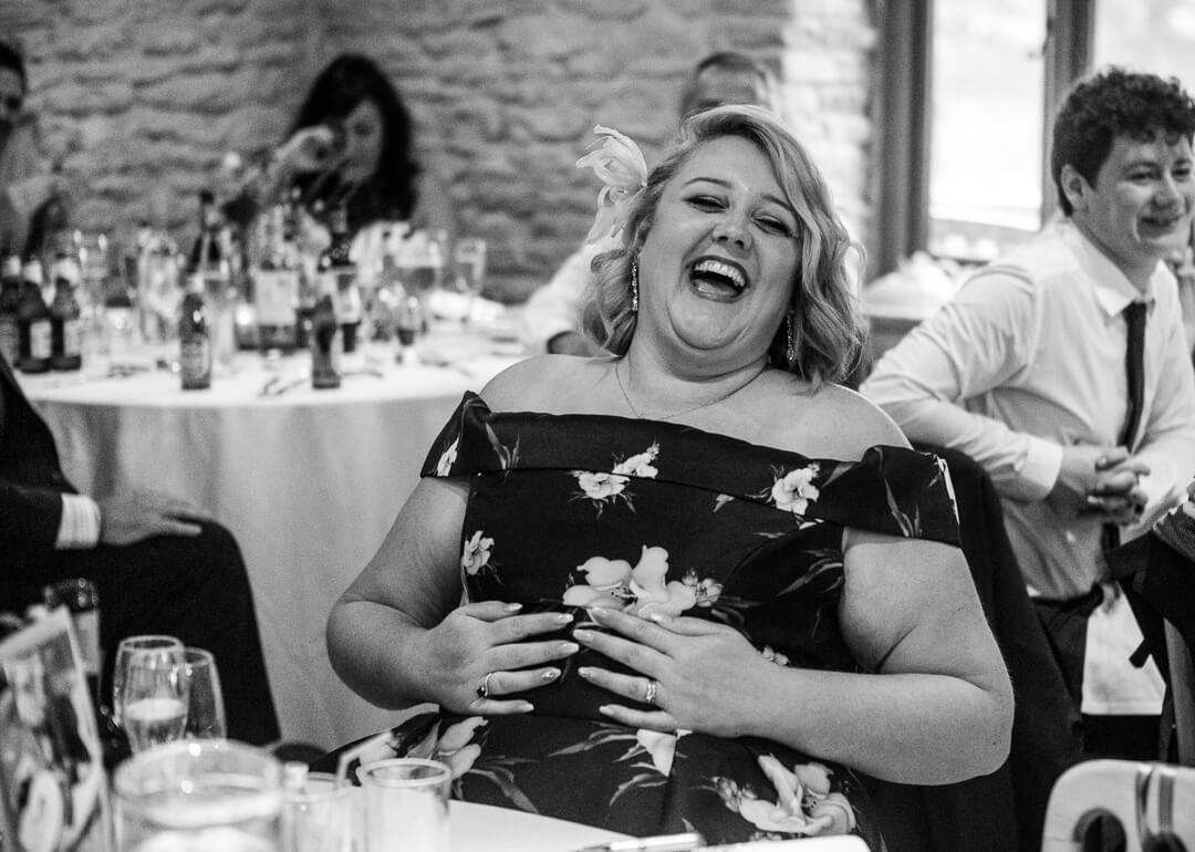 Wedding guest laughing at speeches