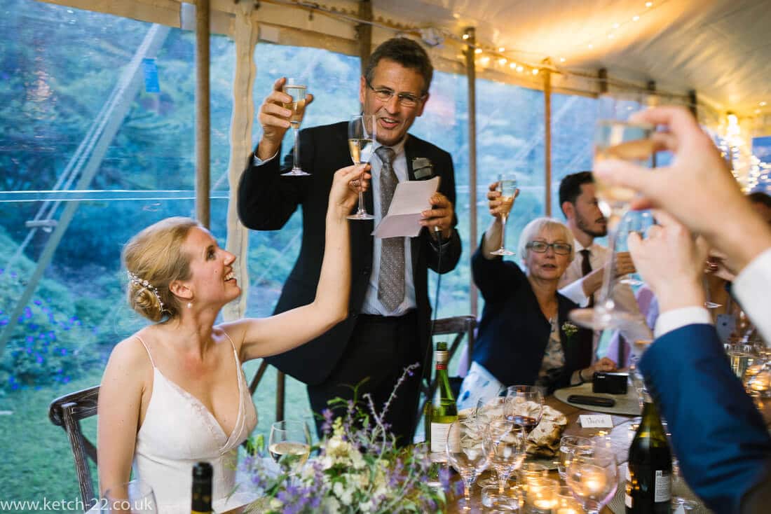 Bride and father toasting at wedding speeches