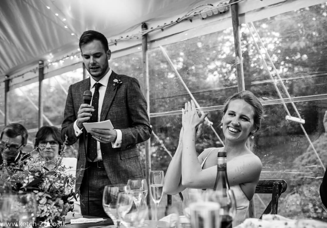 Bride applauding grooms wedding speech