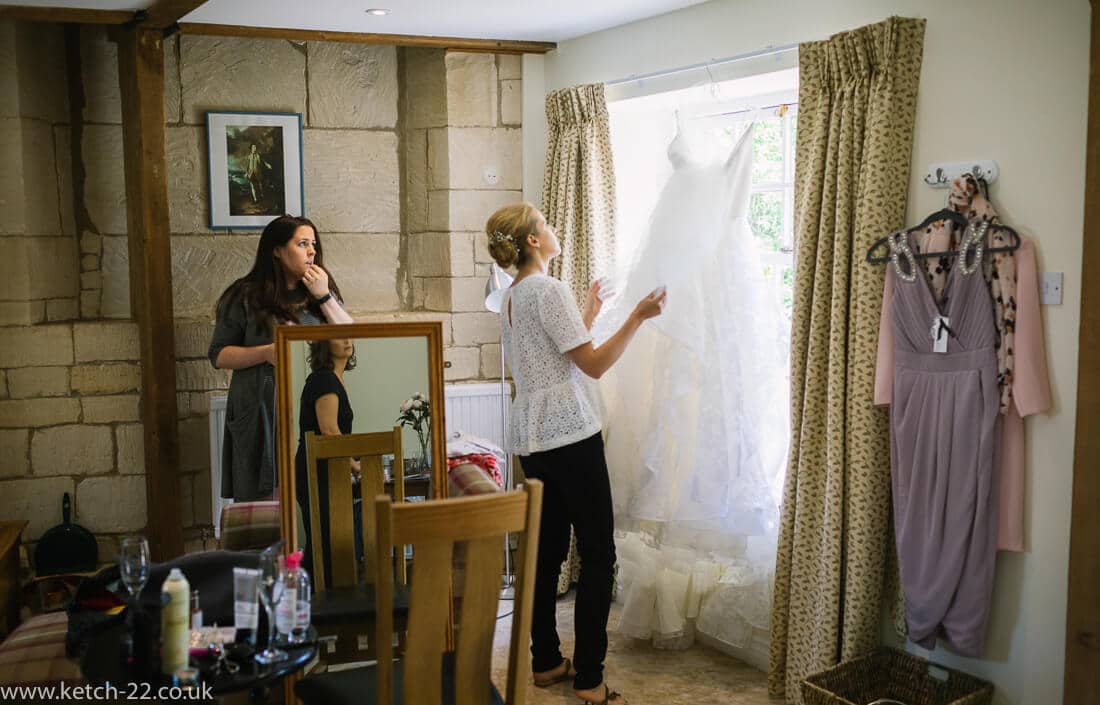 Bride inspecting her wedding dress