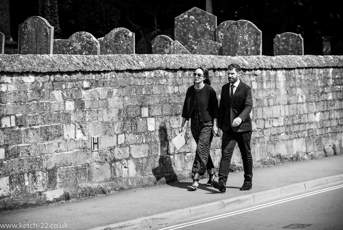 Wedding guests arriving on street