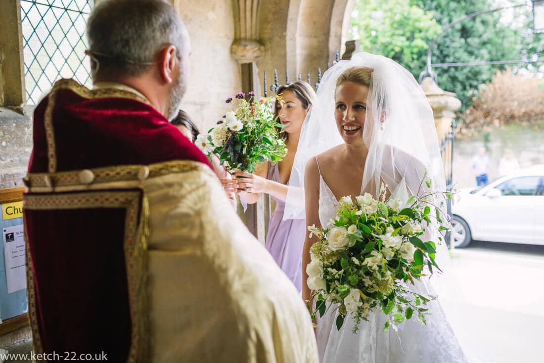 Bride talking to vicar before wedding ceremony