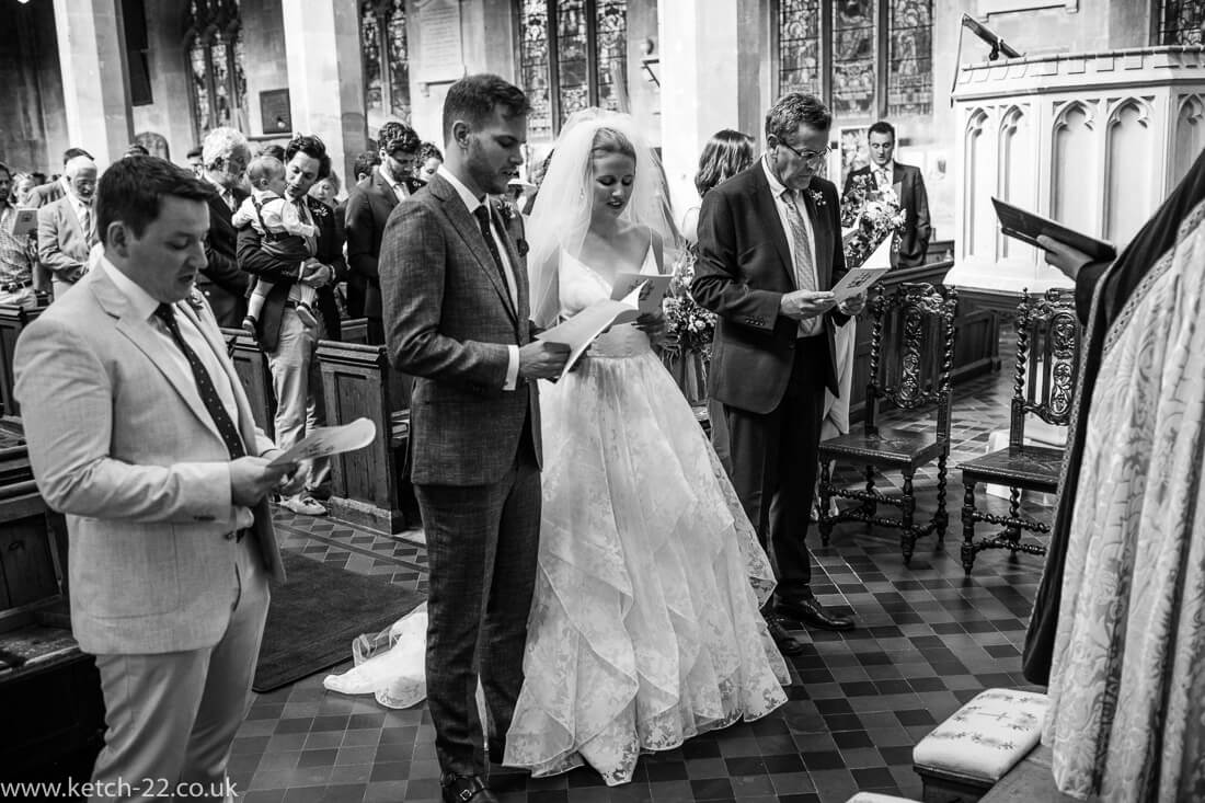 Bride and groom singing at church wedding