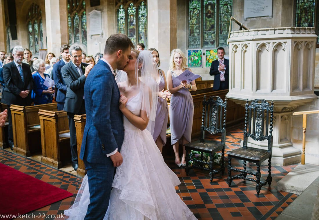 Bride and groom kissing at wedding ceremony