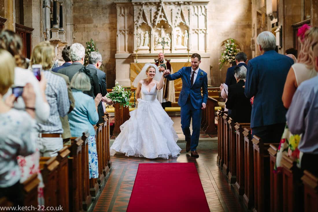 Bride and groom celebrate as they leave wedding ceremony