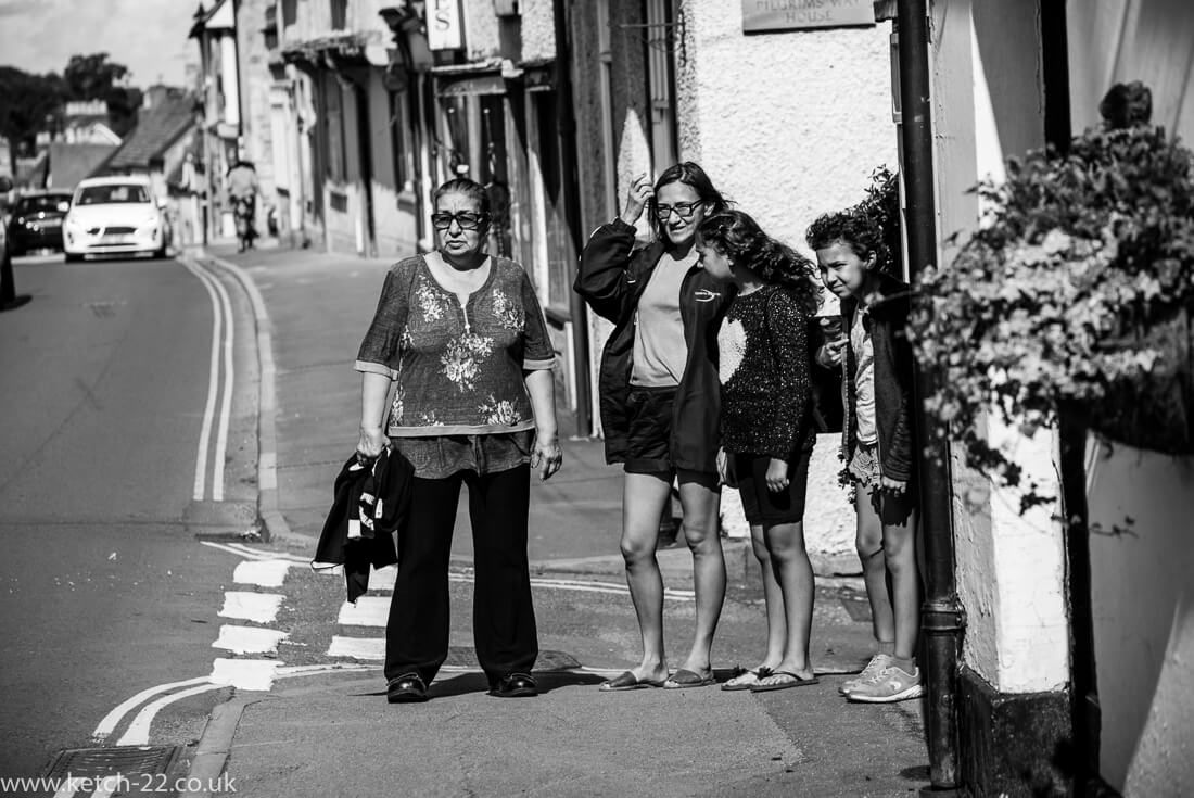 People on the street looking at bride and groom