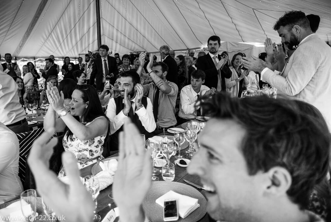 Wedding guests cheering bride and groom at Winchcombe wedding