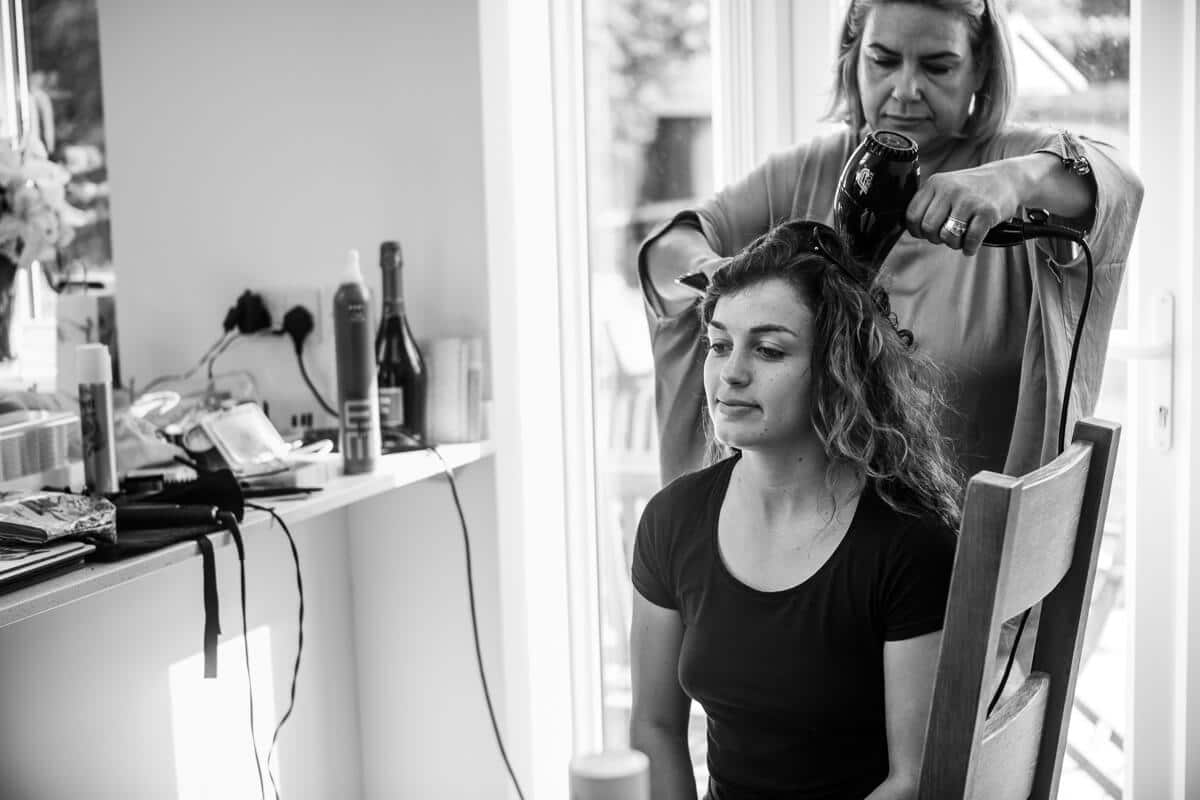 Brides sister having her hair done before wedding