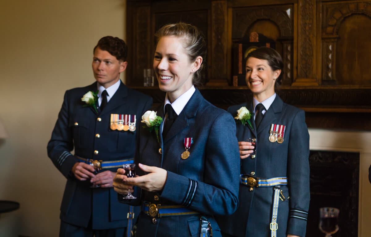 RAF girls relaxing with drink just prior to Country house wedding