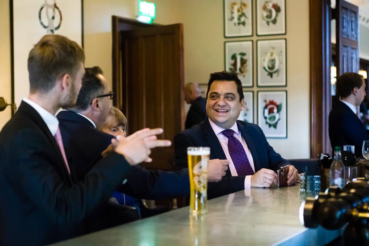 Wedding guest relaxing in bar just prior to wedding ceremony