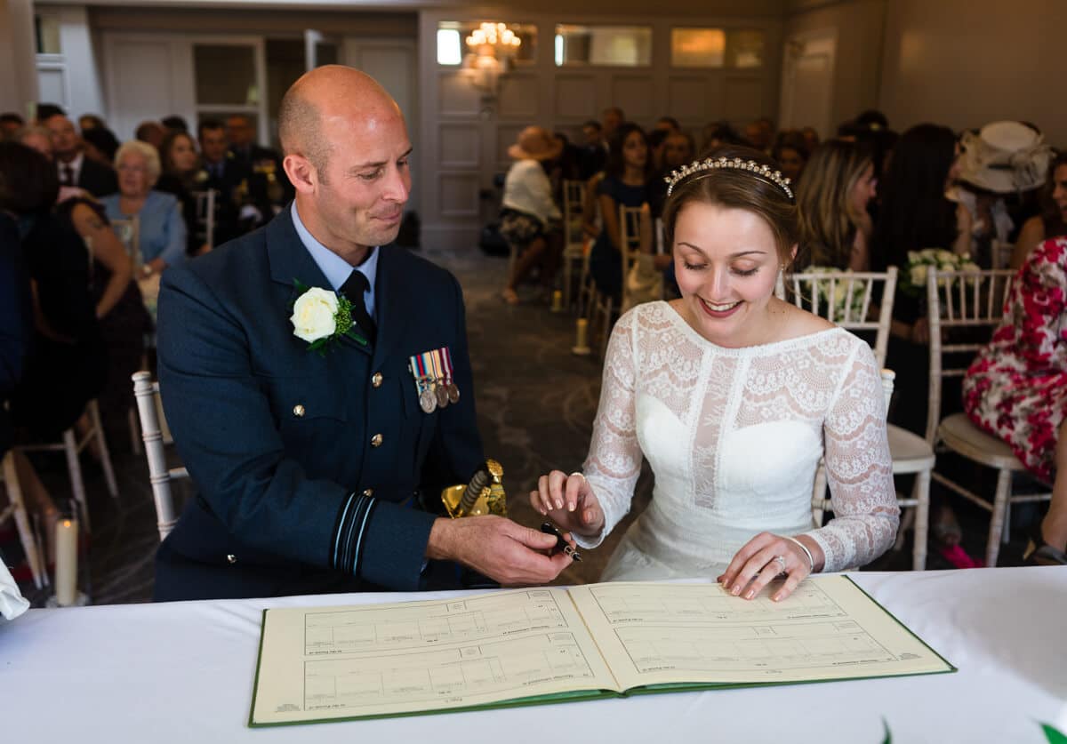 Bride and groom signing the wedding registrar