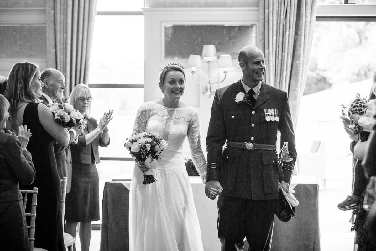 Bride and groom leaving wedding ceremony