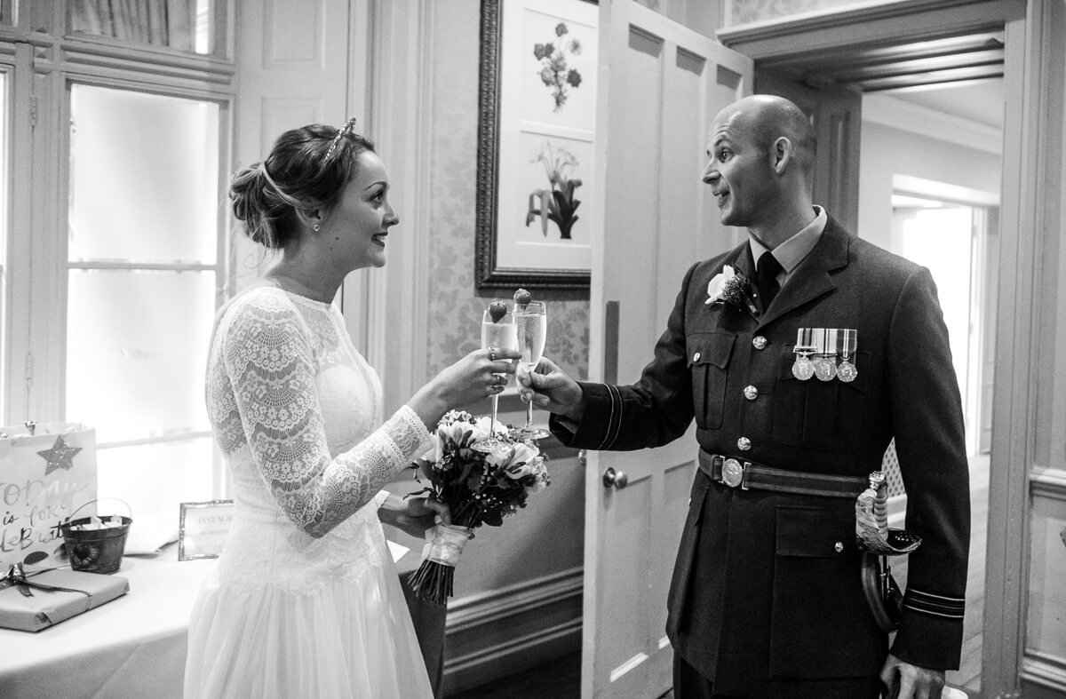 Bride and groom toasting eachother just after wedding