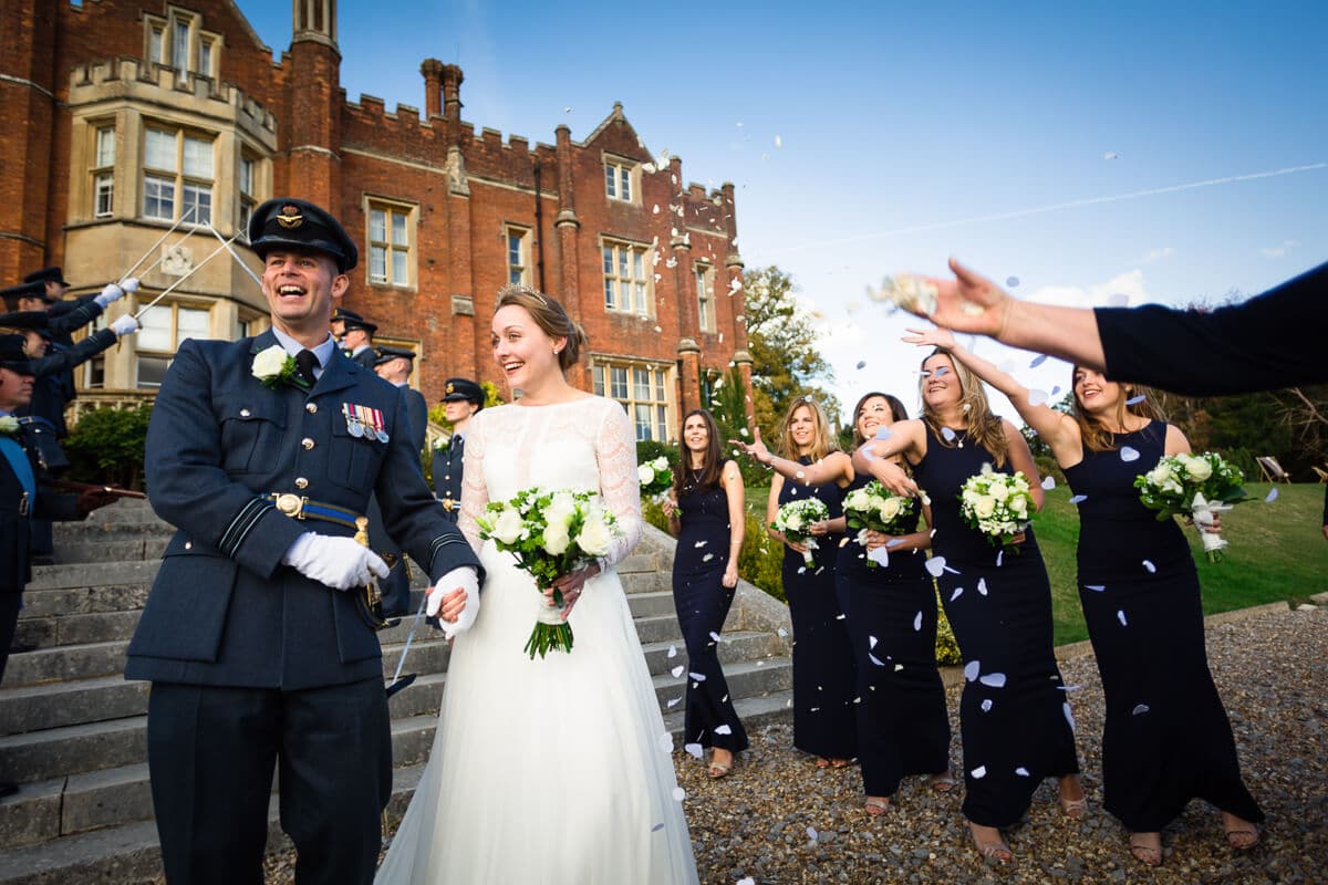 Bride and groom getting showered with confetti at De Vere Latimer Estate Wedding