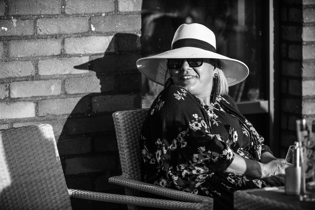 Wedding guest wearing large white hat