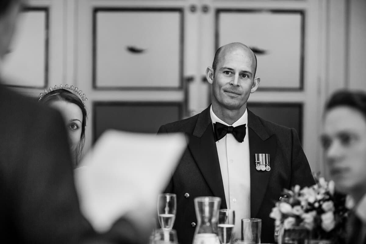 Groom listening to wedding speeches