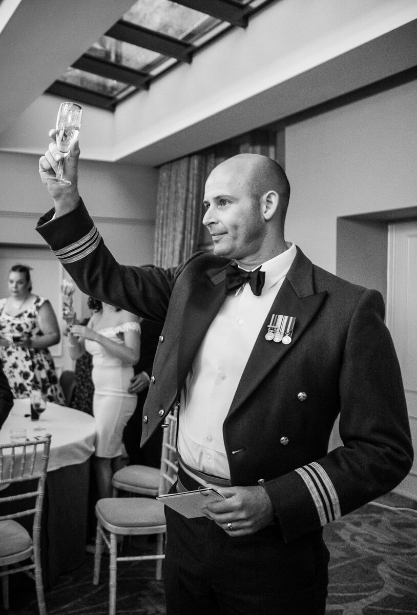 Groom raises a glass to the bride