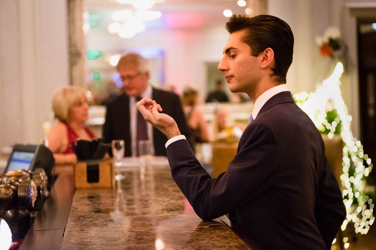 Posh wedding guest checking his nails