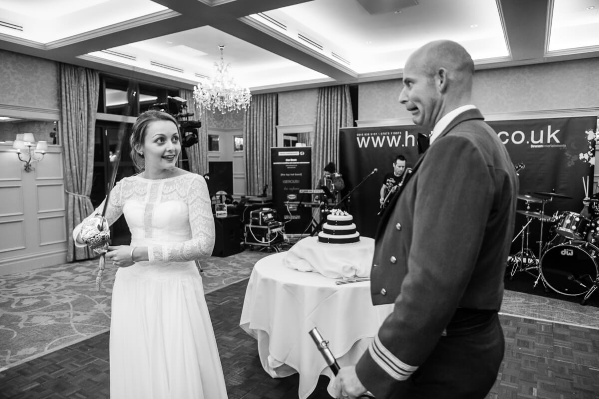 Bride threatening RAF groom with sword