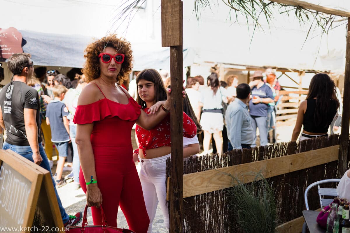 Eccentric Spanish woman wearing red with her daughter at Grazalema fiesta