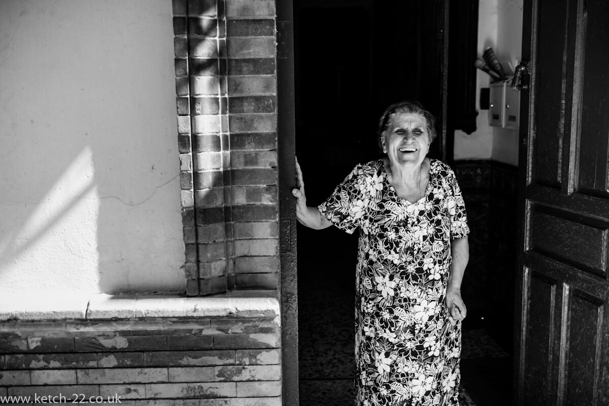 Lady from Grazalema laughing in doorway