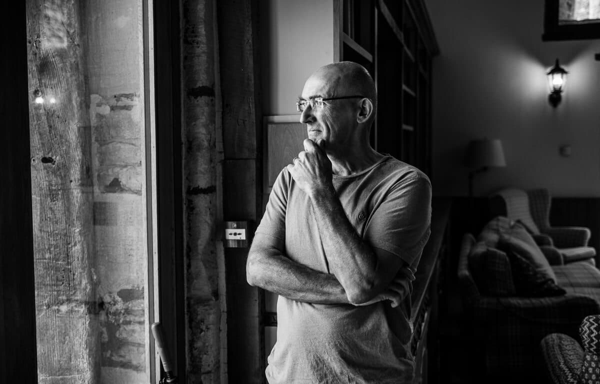 Grooms Dad looking out of Window at Gloucestershire Wedding