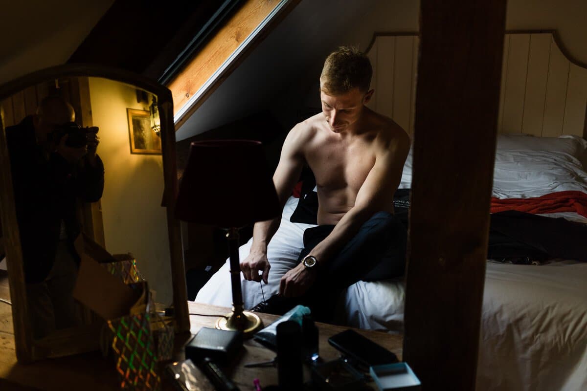 Groom putting on shoes