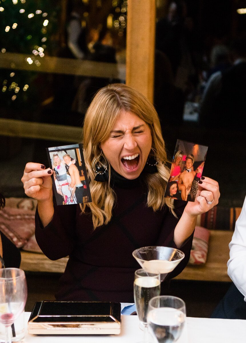 Wedding guest showing off photos at speeches