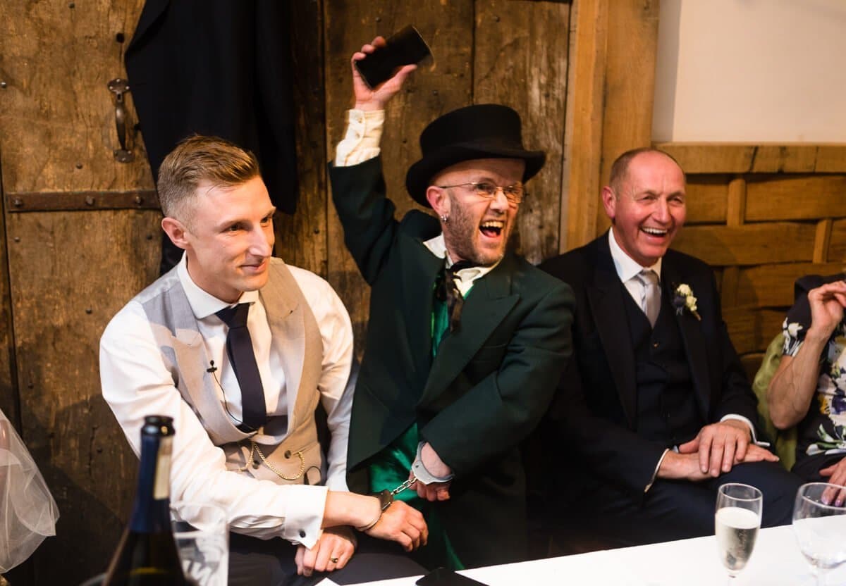 Groom is hand cuffed by dwarf at Gloucestershire wedding