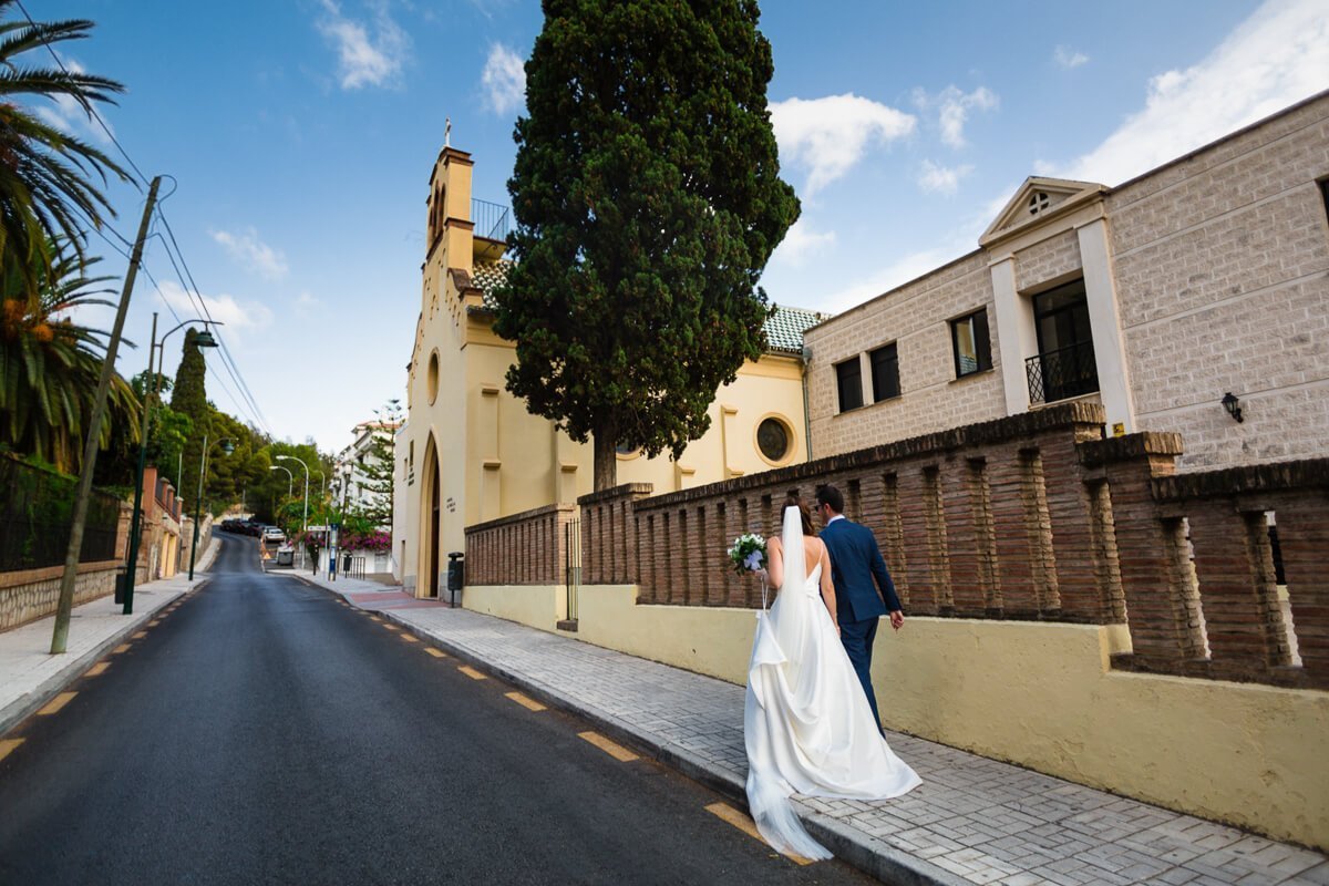 Bride and groom walking to church at Spanish wedding