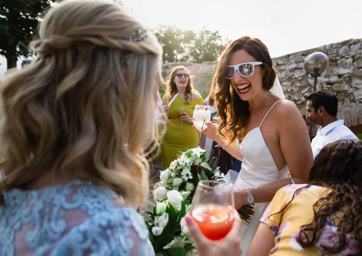 Bride wearing sunglasses and laughing