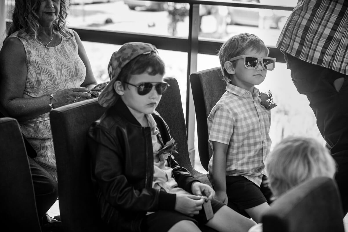 Kids wearing sunglasses at wedding ceremony